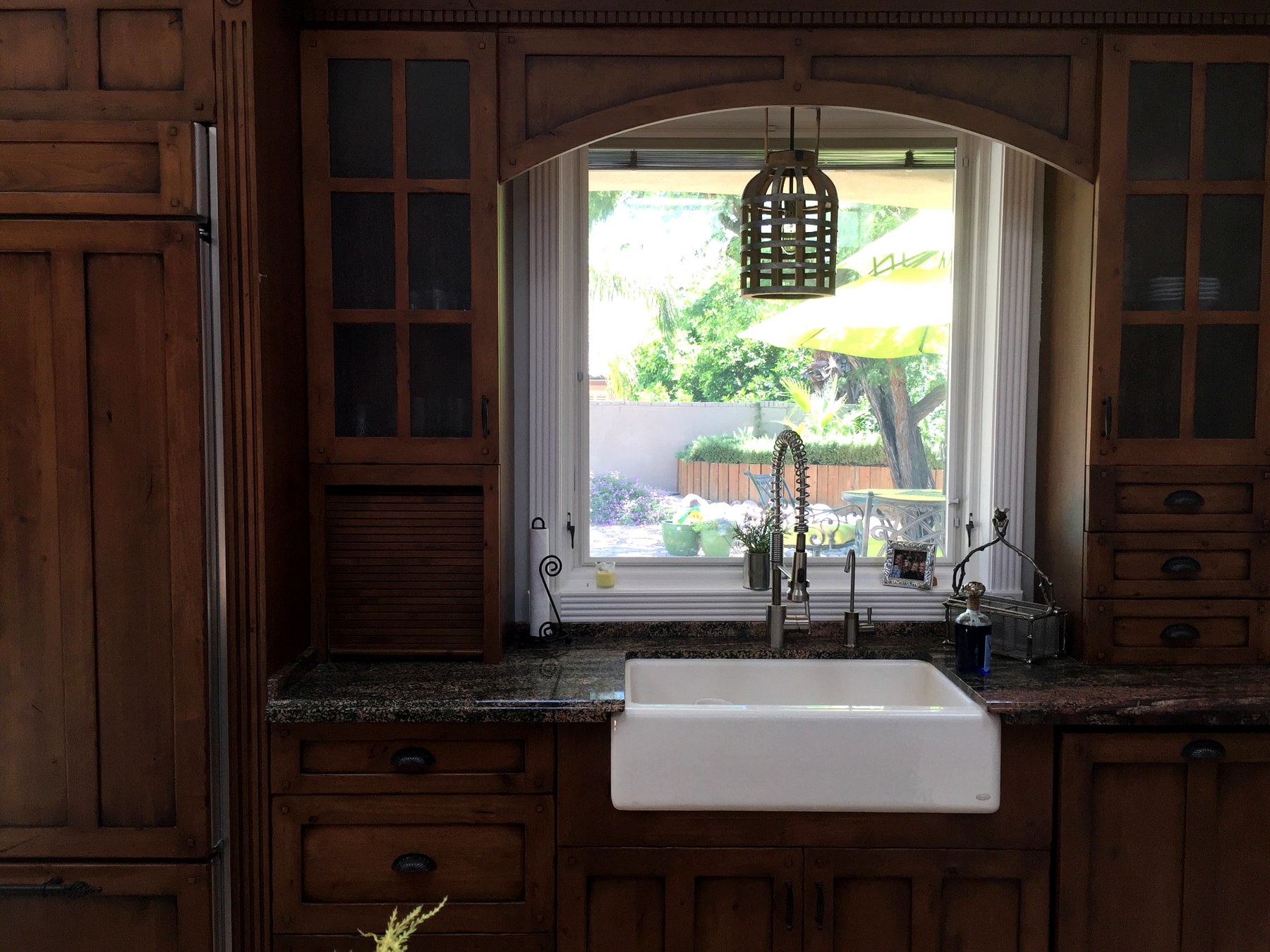 North Scottsdale kitchen farmhouse sink framed by custom wood cabinetry