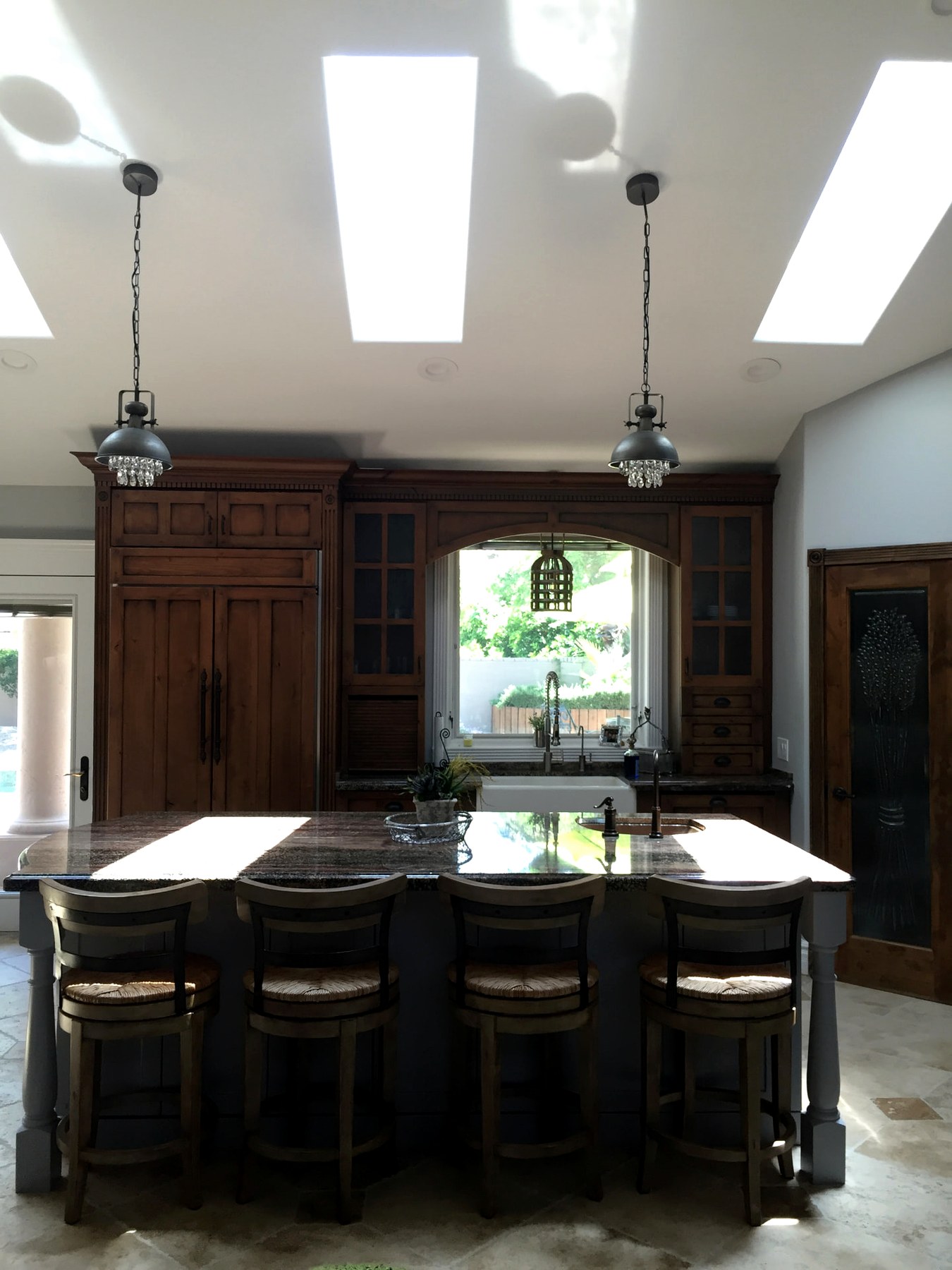 North Scottsdale kitchen island beneath skylights and pendant lights