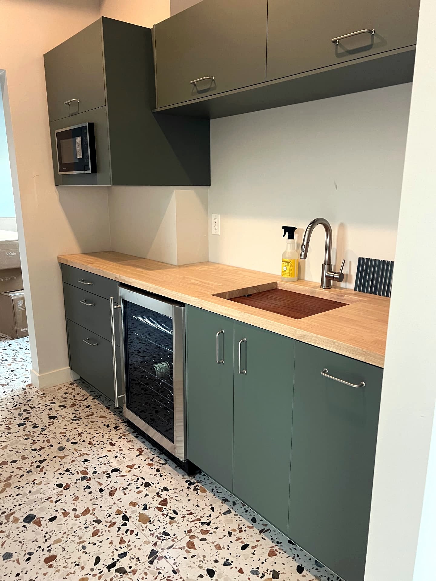 Central Phoenix pool house kitchenette with green cabinetry