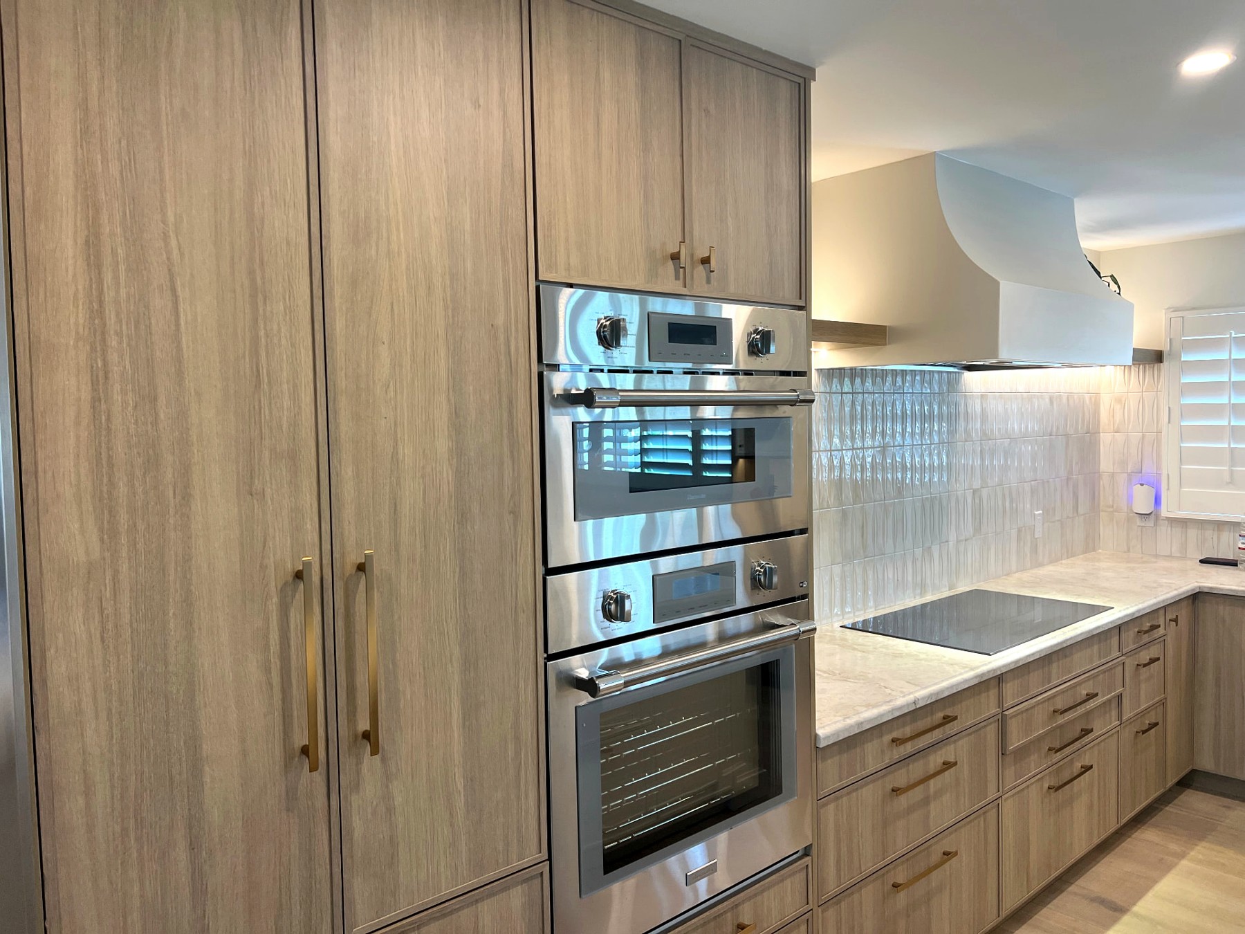 Phoenix home remodel kitchen with double wall ovens and full-height wood cabinetry