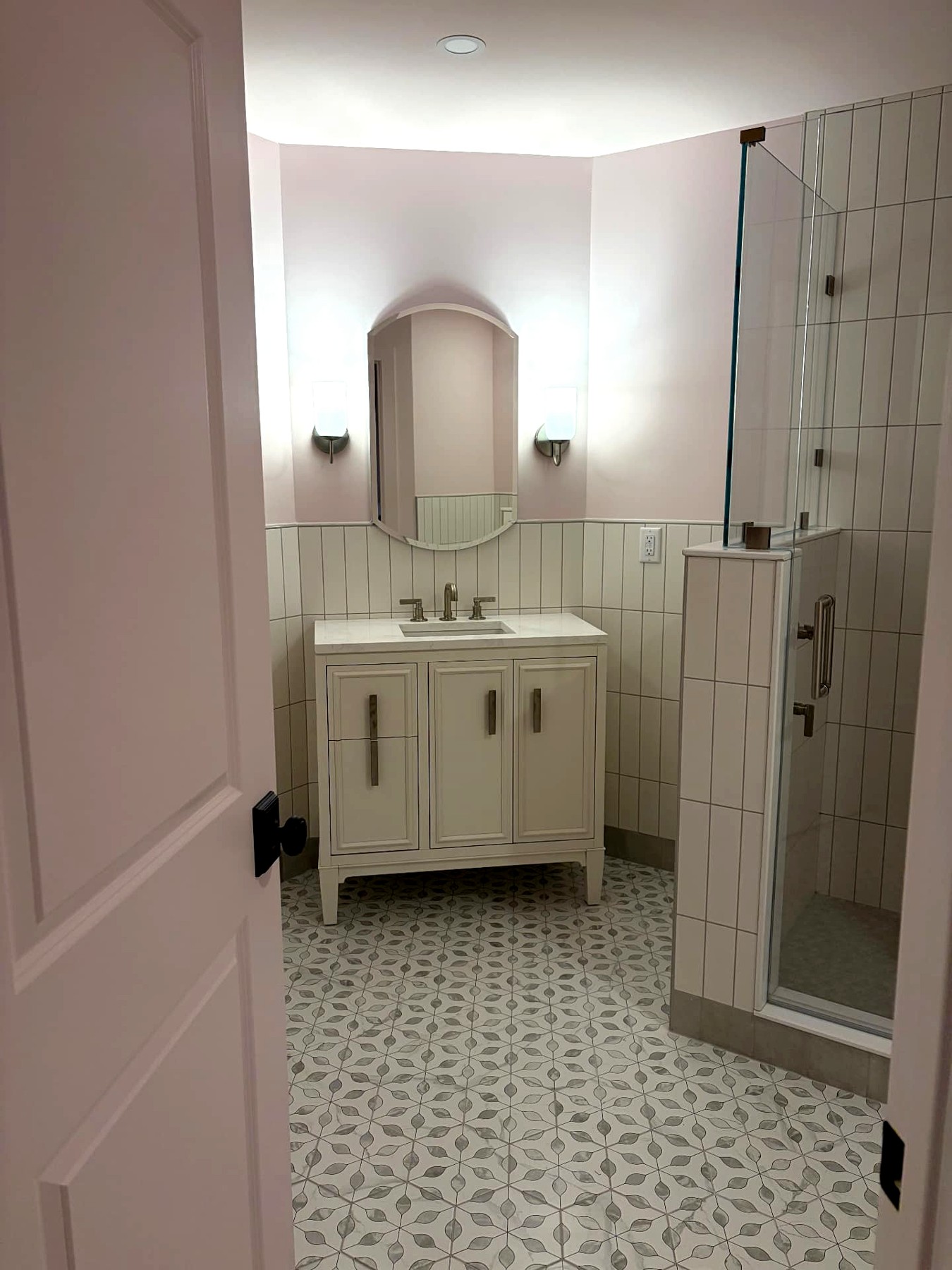 Phoenix home remodel bathroom with vanity, sconces, and glass shower