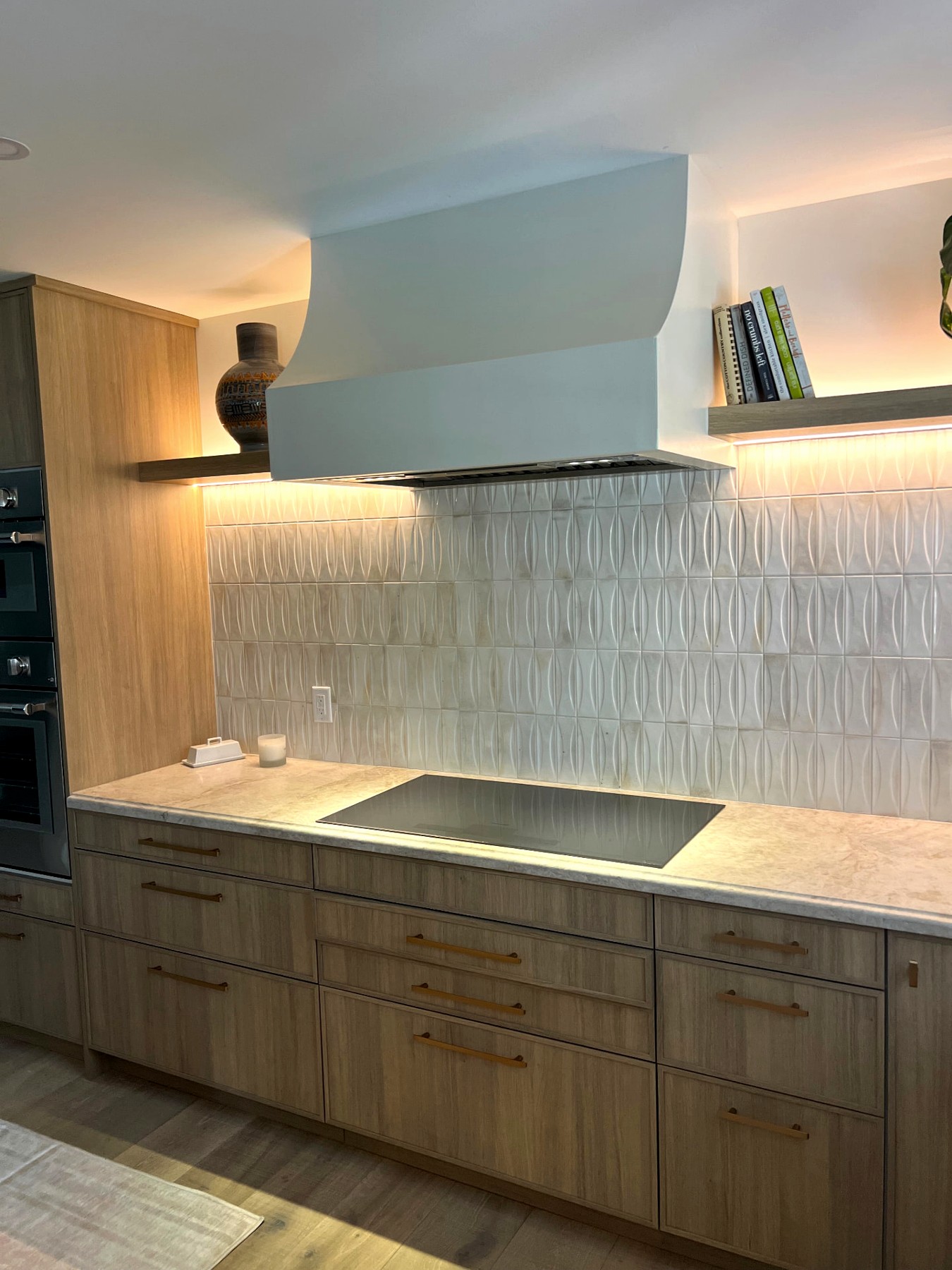 Phoenix home remodel cooktop with sculpted hood and floating shelves